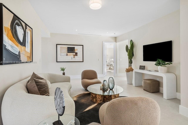 living area featuring baseboards