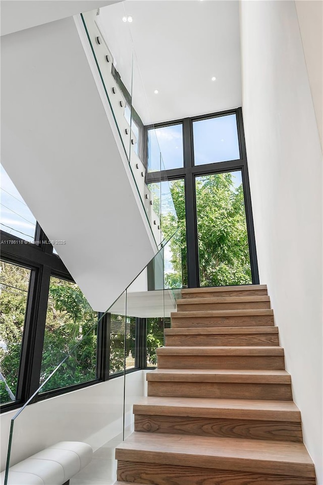 stairs featuring floor to ceiling windows