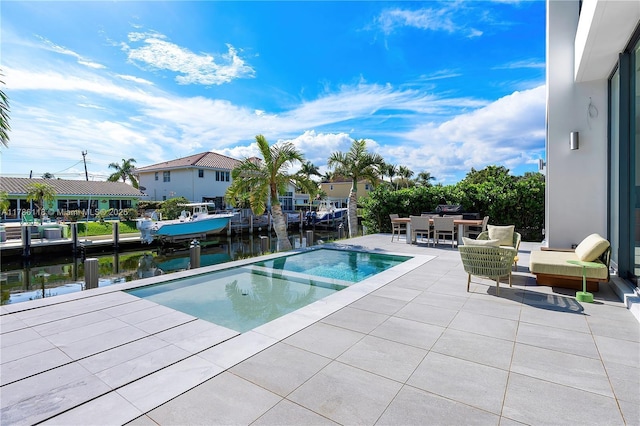 view of swimming pool with a water view, a patio area, outdoor dining area, and an in ground hot tub
