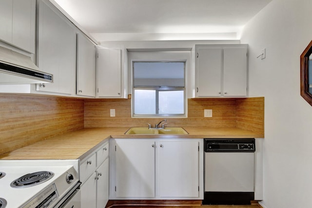 kitchen featuring light countertops, white appliances, decorative backsplash, and a sink