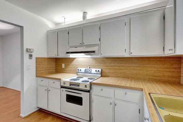 kitchen featuring a sink, under cabinet range hood, white electric stove, baseboards, and light countertops