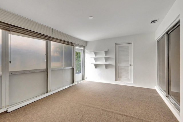 interior space featuring visible vents, a closet, and carpet flooring