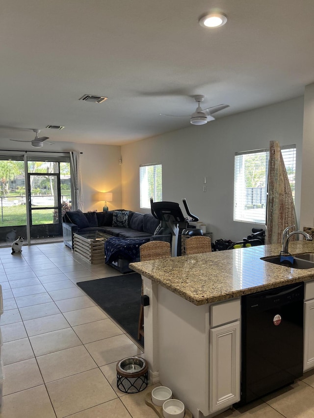 kitchen featuring dishwasher, ceiling fan, open floor plan, and a sink
