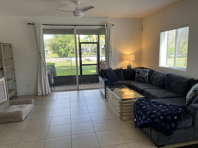 living area with light tile patterned flooring, a healthy amount of sunlight, and a ceiling fan
