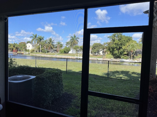 view of yard featuring central AC and fence