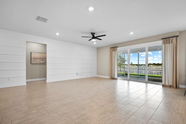 empty room featuring ceiling fan, baseboards, visible vents, and recessed lighting