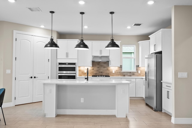 kitchen with decorative backsplash, light countertops, visible vents, and appliances with stainless steel finishes