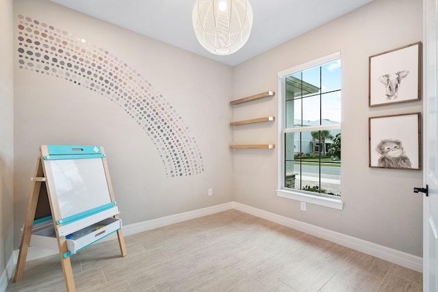 unfurnished room with a wealth of natural light and baseboards