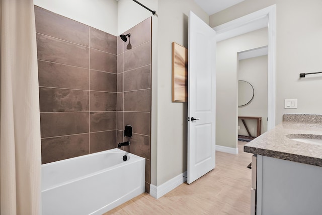 full bath featuring tub / shower combination, baseboards, and vanity