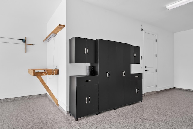 interior details featuring baseboards and speckled floor