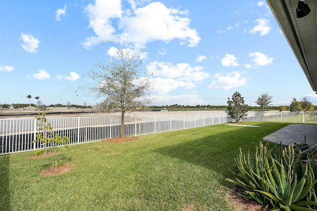 view of yard featuring a fenced backyard and a water view