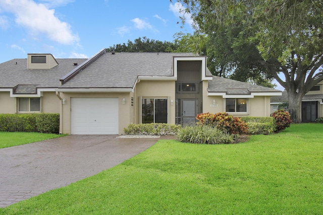 6907 Fountains Cir, Lake Worth, FL 33467 - view of front of property with concrete driveway, roof with shingles, stucco siding, and a garage