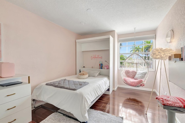 6290 Windchime Pl, Boynton Beach, FL 33472 - bedroom with a textured ceiling, baseboards, and wood finished floors