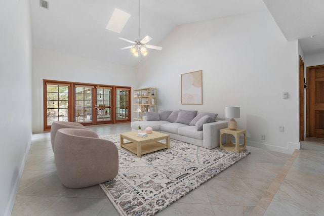 living area with visible vents, baseboards, high vaulted ceiling, a ceiling fan, and light tile patterned floors
