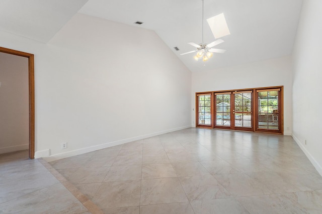 unfurnished room with ceiling fan, high vaulted ceiling, baseboards, a skylight, and visible vents