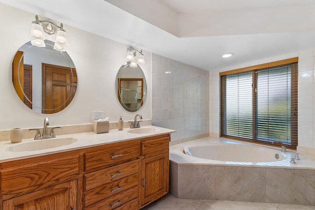 bathroom featuring a garden tub, a sink, tile patterned flooring, and double vanity