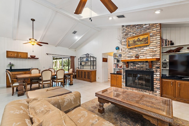 living room featuring ceiling fan, visible vents, a fireplace, beam ceiling, and light tile patterned floors