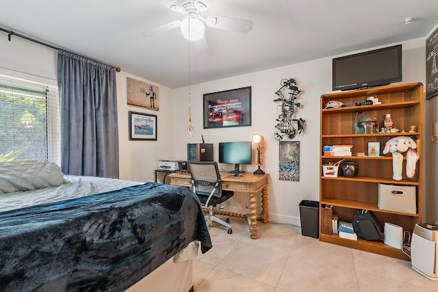 bedroom with a ceiling fan, baseboards, and light tile patterned floors