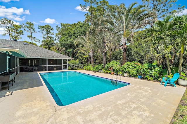 pool with a patio area and a sunroom