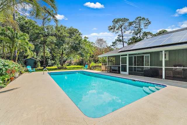outdoor pool with a patio area and a sunroom