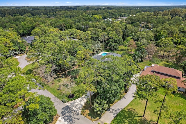 drone / aerial view featuring a forest view