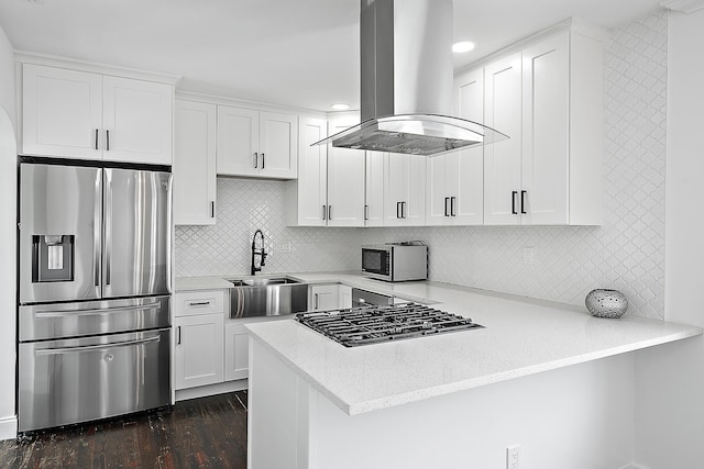 725 N Ocean Breeze, Lake Worth Beach, FL 33460 - kitchen featuring stainless steel appliances, island range hood, a peninsula, a sink, and white cabinets