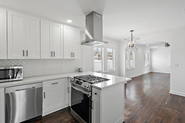 725 N Ocean Breeze, Lake Worth Beach, FL 33460 - kitchen with stainless steel appliances, island range hood, open floor plan, a peninsula, and light countertops