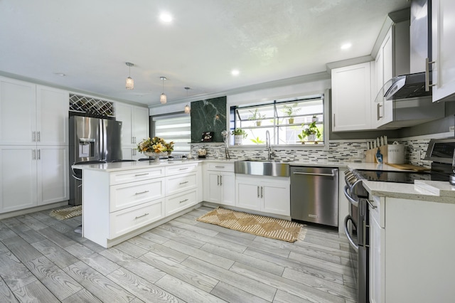 1050 Singer Dr, Singer Island, FL 33404 - kitchen featuring stainless steel appliances, backsplash, wall chimney range hood, a sink, and white cabinetry