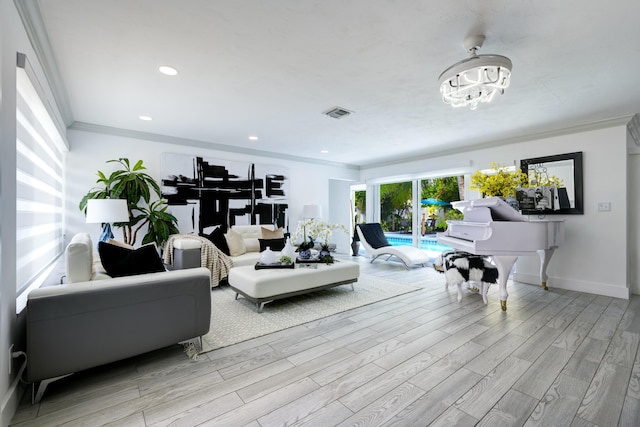 1050 Singer Dr, Singer Island, FL 33404 - living area with an inviting chandelier, ornamental molding, wood finished floors, and baseboards