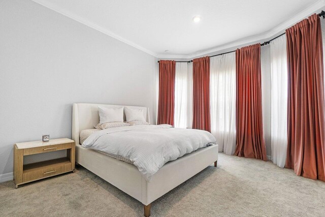bedroom featuring carpet flooring and ornamental molding