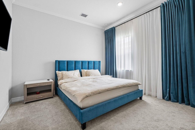 bedroom with carpet flooring, crown molding, visible vents, and baseboards