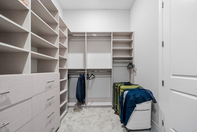 walk in closet featuring carpet