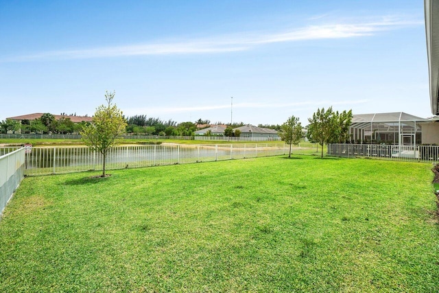 view of yard featuring a fenced backyard and a water view
