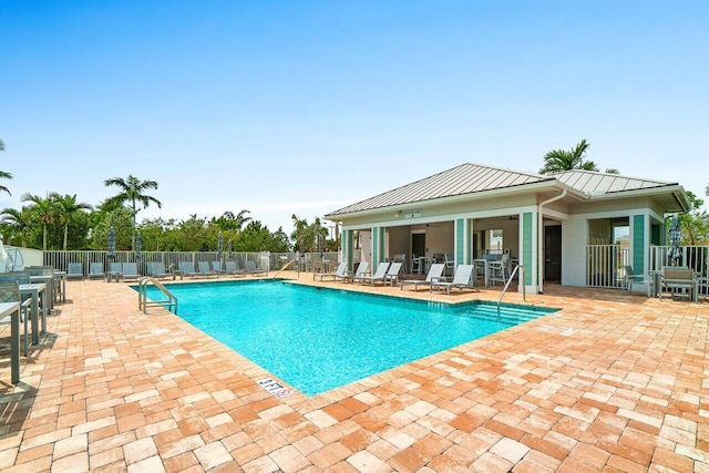 community pool featuring a patio area and fence