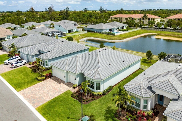drone / aerial view with a water view and a residential view