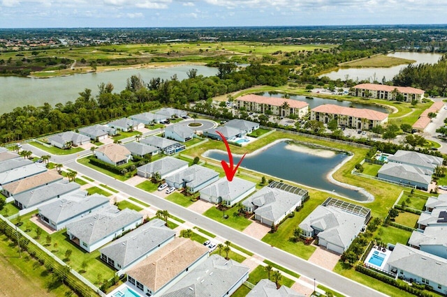 drone / aerial view with a water view and a residential view