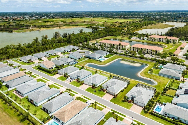 drone / aerial view featuring a water view and a residential view