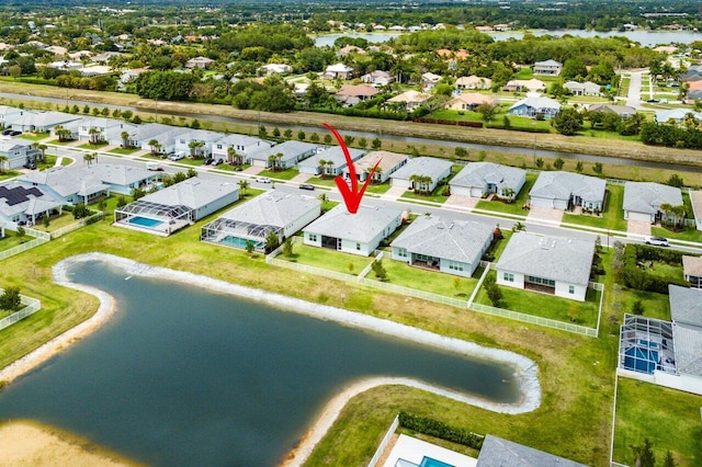 bird's eye view featuring a water view and a residential view