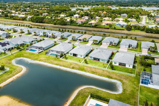 birds eye view of property with a residential view and a water view