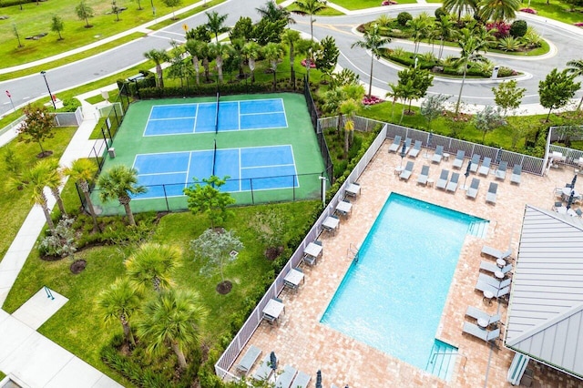 exterior space with fence and a tennis court