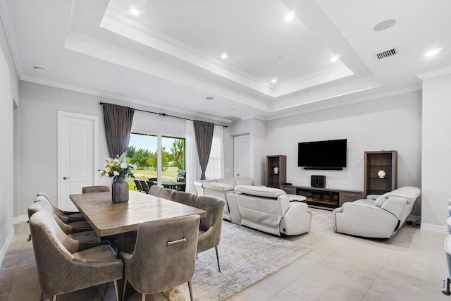 dining room featuring visible vents, baseboards, light tile patterned flooring, and a tray ceiling