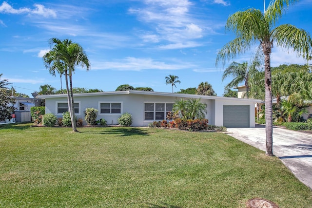 single story home featuring an attached garage, stucco siding, driveway, and a front yard