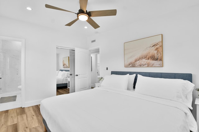 bedroom with visible vents, a closet, wood finished floors, recessed lighting, and connected bathroom