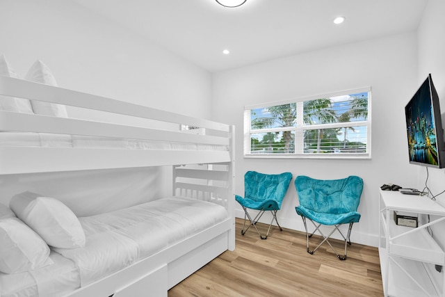 bedroom with recessed lighting, baseboards, and wood finished floors