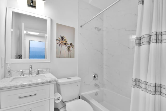 bathroom featuring toilet, shower / tub combo, and vanity
