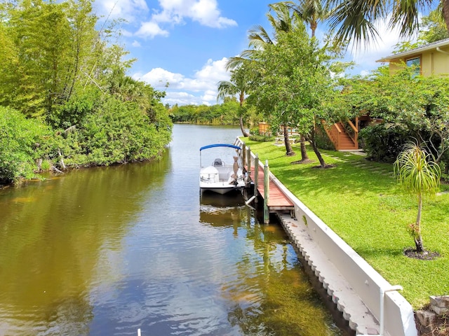 dock area featuring a lawn and a water view