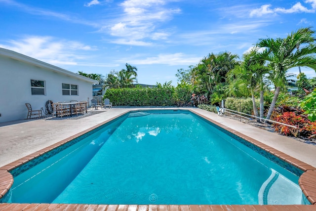 view of swimming pool with a patio and a fenced in pool