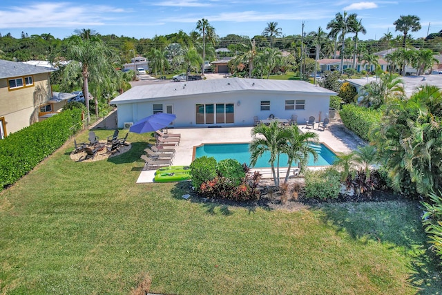back of house featuring a fire pit, a fenced backyard, stucco siding, a patio area, and a yard