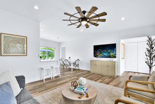 living area with ceiling fan, recessed lighting, and wood finished floors