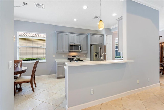 kitchen with light tile patterned floors, stainless steel appliances, light countertops, and gray cabinets